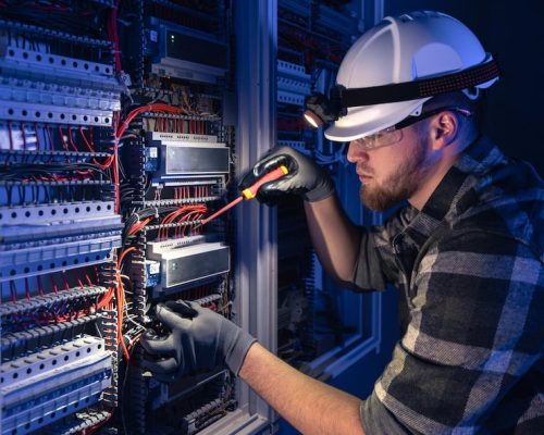 male-electrician-works-switchboard-overalls-against-backdrop-emergency-lighting_169016-66398 male-electrician-works-switchboard-overalls-against-backdrop-emergency-lighting_169016-66398